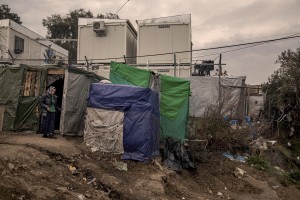 An Afghan woman is seen outside the tent where she lives in the Moria refugee camp on the island of Lesbos in Greece on February 20, 2020. About 20000 migrants and asylum seekers – mostly coming from Afghanistan and Syria – live in the official Moria camp and in the olive grove that is located nearby.