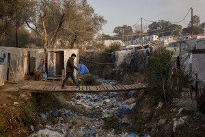 An Afghan man walks on a bridge in the Moria refugee camp on the island of Lesbos in Greece on February 19, 2020. About 20000 migrants and asylum seekers – mostly coming from Afghanistan and Syria – live in the official Moria camp and in the olive grove that is located nearby.