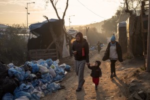 People walk inside the Moria refugee camp on the island of Lesbos in Greece on February 19, 2020. About 20000 migrants and asylum seekers – mostly coming from Afghanistan and Syria – live in the official Moria camp and in the olive grove that is located nearby.