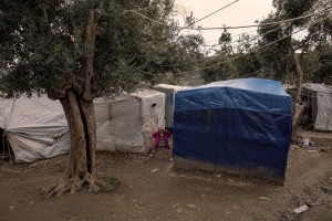 A girl is seen among the tents of the Moria refugee camp on the island of Lesbos in Greece on February 21, 2020. About 20000 migrants and asylum seekers – mostly coming from Afghanistan and Syria – live in the official Moria camp and in the olive grove that is located nearby.