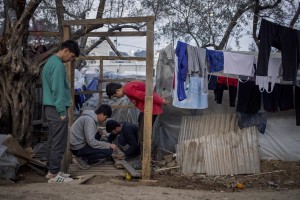 Afghan men build a tent inside the Moria refugee camp on the island of Lesbos in Greece on February 19, 2020. About 20000 migrants and asylum seekers – mostly coming from Afghanistan and Syria – live in the official Moria camp and in the olive grove that is located nearby.