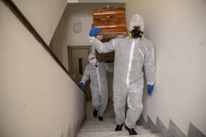 Angelo and Enrico carry a coffin before recovering a person’s body during the coronavirus emergency in Naples, Italy on March 27, 2020. Although the person did not die from coronavirus, the work of funeral agency officials is among those most at risk during this emergency, as often can find in contact with corpses of people who died by coronavirus and the risk of contagion is very high.