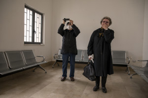 Giorgio and Elisabetta witness the cremation of their relative through a monitor inside a video room of the crematory in Naples, Italy on March 27, 2020. Due to the coronavirus emergency it is no longer possible to celebrate funerals inside churches and funeral processions are prohibited. In the case of cremation, relatives can greet the deceased for the last time through a monitor that shows when the coffin is introduced into the crematorium.