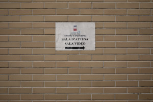 A sign indicates how to get to the video room of the crematory in Naples, Italy on March 27, 2020. Due to the coronavirus emergency it is no longer possible to celebrate funerals inside churches and funeral processions are prohibited. In the case of cremation, relatives can greet the deceased for the last time through a monitor that shows when the coffin is introduced into the crematorium.