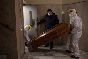 Workers carry a coffin before recovering a person’s body during the coronavirus emergency in Naples, Italy on April 1, 2020. Although the person did not die from coronavirus, the work of funeral agency officials is among those most at risk during this emergency, as often can find in contact with corpses of people who died by coronavirus and the risk of contagion is very high.