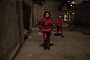 Volunteers from the Italian Red Cross are seen during food distribution for homeless people in Naples, Italy on April 2, 2020. Homeless are experiencing a double emergency: the first one due to their condition, the second one linked to the spread of the coronavirus that caused the closure of many assistance centers because of possible contagion.