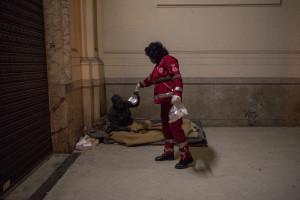 A volunteer from the Italian Red Cross distributes a meal to a homeless person in Naples, Italy on April 2, 2020. Homeless are experiencing a double emergency: the first one due to their condition, the second one linked to the spread of the coronavirus that caused the closure of many assistance centers because of possible contagion.