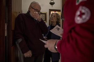 Vittorio, 84 years old is moved while his wife Annamaria, 82 years old looks at him after receiving medicines from a volunteer of the Italian Red Cross, during coronavirus emergency in Naples, Italy on April 2, 2020. Vittorio has a colon problem,  but neither he nor his wife can move from home because of their age, so once a week the volunteers of the Italian Red Cross bring him the medicines he needs directly at home.