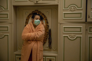 Alla is seen while a nurse of the Italian Red Cross checks the pressure of her mother after an emergency call received in the night, for suspected coronavirus symptoms in Naples, Italy on April 7, 2020.
