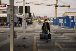 A woman wearing a mask is seen inside the port of the city on the second day of unprecedented lockdown across of all Italy imposed to slow the spread of coronavirus in Naples, Southern Italy on March 11, 2020.