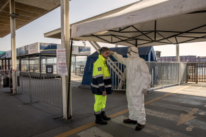 Medical officers check the temperature each other in the port of Naples, Italy on March 11, 2020. In the evening of March 9, 2020 Prime Minister Giuseppe Conte has officially declared that the entire Italian peninsula will be considered “red zone” due to the fast spread of the coronavirus.