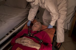 Isaia, 80 years old and suspected covid-19 positive is put on a stretcher before being transferred to the hospital after an emergency call to the Italian Red Cross in Ranica, province of Bergamo, Northern Italy on April 11, 2020. Before the emergency call, Isaia had had a high fever for several days.