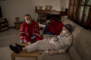 Laura, suspected covid-19 positive is visited by a nurse of the Italian Red Cross after an emergency call in Nembro, province of Bergamo, Northern Italy on April 12, 2020.