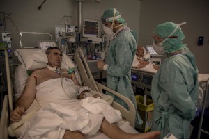 Nurses take care of their patients who lie in bed inside the coronavirus intensive care unit of the “Poliambulanza Foundation” hospital in Brescia, Italy on April 9, 2020. “Poliambulanza Foundation” is a non-profit multispecialist private hospital, affiliated with the National Health Service.