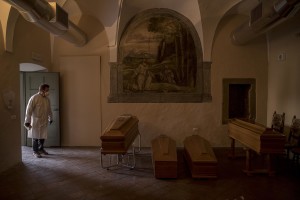 A funeral agency employee is seen inside the mortuary of the “Pesenti Fenaroli” hospital in Alzano Lombardo, Northern Italy, on April 13, 2020.