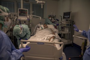 Nurses take care of their patients who lie in bed inside the coronavirus intensive care unit of the “Poliambulanza Foundation” hospital in Brescia, Italy on April 9, 2020. “Poliambulanza Foundation” is a non-profit multispecialist private hospital, affiliated with the National Health Service.