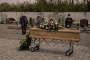 Relatives of a 47 years old man died of coronavirus attend the blessing of his coffin by a priest inside the cemetery of Locate Bergamasco, province of Bergamo, Northern Italy on April 16, 2020.