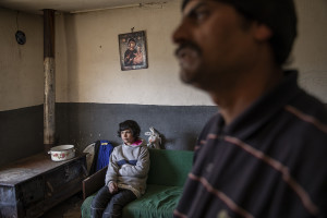 Goran, 38 years old and Sibella, 10 years old are portrayed inside their house in the area of Shutka in Skopje, North Macedonia on February 29, 2020. During the winter Goran, like many others households, burns coal, scrap wood, textiles or trash in order to keep warm. This obsolete heating system is one of the biggest contributors to air pollution in the country. Although the electricity tariffs in Macedonia are among the lowest in Europe, energy can cost a third or even half of a citizen’s  average monthly salary. This is the reason why many residents burn wood to heat their home, often buying it on the black market where it costs less, but is more toxic to the environment.