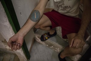 Gaetano Ippolito, 46 years old shows a tattoo depicting the logo of Napoli soccer in the “Rione Sanità” in Naples, Italy on June 17, 2020. Since the pandemic broke out, Gaetano has no longer been able to find any type of job, even on an occasional basis. Popular neighborhoods are those that more than others are suffering from the economic crisis generated by the coronavirus. The rate of poverty and unemployment that was higher than the national average in Southern Italy even before the pandemic, increased following the lockdown imposed by the government to counter the spread of the coronavirus, which blocked the country’s economy for more than two months.