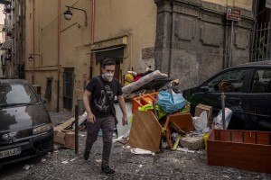 A boy walks among the garbage in the “Quartieri Spagnoli” in Naples, Italy on June 16, 2020. Popular neighborhoods are those that more than others are suffering from the economic crisis generated by the coronavirus. The rate of poverty and unemployment that was higher than the national average in Southern Italy even before the pandemic, increased following the lockdown imposed by the government to counter the spread of the coronavirus, which blocked the country’s economy for more than two months.