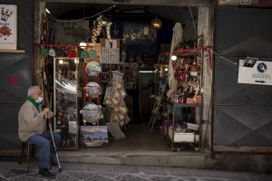 A man is seen outside a shop in San Gregorio Armeno street in Naples, Southern Italy on June 16, 2020. San Gregorio Armeno is the undisputed world capital of the nativity and home to the artisans and merchants who specialize in the art of the Neapolitan presepe. During the whole year million tourists come to see these traditional shops and buy the original miniature figurines, but due to the spread of the coronavirus this type of tourism and business have stopped.