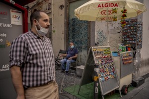 A waiter (left) and a peddler (right) are seen in the “Quartieri Spagnoli” in Naples, Italy on June 16, 2020. Popular neighborhoods are those that more than others are suffering from the economic crisis generated by the coronavirus. The rate of poverty and unemployment that was higher than the national average in Southern Italy even before the pandemic, increased following the lockdown imposed by the government to counter the spread of the coronavirus, which blocked the country’s economy for more than two months.