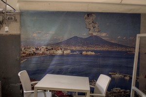 A poster depicting Mount Vesuvius is seen outside a pizzeria in the “Quartieri Spagnoli” in Naples, Italy on June 16, 2020. Popular neighborhoods are those that more than others are suffering from the economic crisis generated by the coronavirus. The rate of poverty and unemployment that was higher than the national average in Southern Italy even before the pandemic, increased following the lockdown imposed by the government to counter the spread of the coronavirus, which blocked the country’s economy for more than two months.