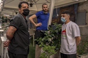 From left: Alessandro, Emanuele and Antonio are seen outside the pizzeria where they work in the “Quartieri Spagnoli” in Naples, Italy on June 16, 2020. Popular neighborhoods are those that more than others are suffering from the economic crisis generated by the coronavirus. The rate of poverty and unemployment that was higher than the national average in Southern Italy even before the pandemic, increased following the lockdown imposed by the government to counter the spread of the coronavirus, which blocked the country’s economy for more than two months.