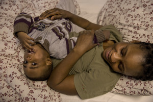 Cynthia, 26 years old from Nigeria and her son Diamond are portrayed inside the structure of Piam onlus where they are hosted in Asti, Northern Italy on January 10, 2020.
