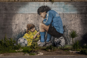 A mural depicting the Argentine soccer legend Diego Armando Maradona and his daughter Dalma is seen in Naples, Southern Italy on November 24, 2021. Diego Armando Maradona died on November 25 of last year and next November 25, 2021 will be the anniversary of his death.