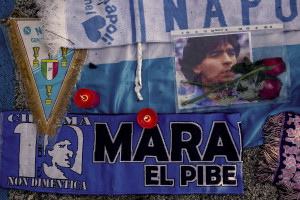 Scarves, football shirts and pictures of the Argentine soccer legend Diego Armando Maradona are seen outside San Paolo stadium after the announcement of his death in Naples, Italy on November 27, 2020.