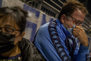 People cry after the death of the Argentine soccer legend Diego Armando Maradona outside San Paolo stadium in Naples, Italy on November 25, 2020.