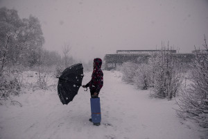 A migrant with an umbrella crosses the snow-covered fields to return to his shelter, found in the rubble of an abandoned factory in Bihac, Bosnia and Herzegovina on January 25, 2021. Lots of migrants avoid staying inside the Bosnian official refugee camps because of the hard conditions in which they are forced to live and also because the people hosted in the official camps  cannot go out freely.