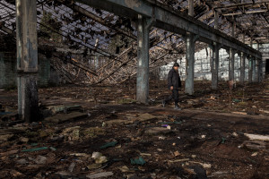 A migrant walks among the rubble of an abandoned factory in Bihac, Bosnia and Herzegovina on January 23, 2021. Lots of migrants avoid staying inside the Bosnian official refugee camps because of the hard conditions in which they are forced to live and also because the people hosted in the official camps  cannot go out freely.