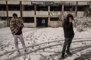 Two migrants are seen outside an abandoned factory in Bihac, Bosnia and Herzegovina on January 26, 2021. Lots of migrants avoid staying inside the Bosnian official refugee camps because of the hard conditions in which they are forced to live and also because the people hosted in the official camps  cannot go out freely.