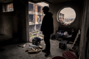 Ataullah, 25 years old from Afghanistan is seen inside an abandoned building in Bihac, Bosnia and Herzegovina on January 24, 2021. Ataullah has been in Bosnia for 7 months and has tried the “game” 8 times to continue his journey to Northern Europe and join his family who live in Germany. The Croatian police has always intercepted him and once broke his phone and glasses.