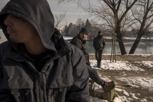 Migrants are seen outside an abandoned building in Bihac, Bosnia and Herzegovina on January 27, 2021. Lots of migrants avoid staying inside the Bosnian official refugee camps because of the hard conditions in which they are forced to live and also because the people hosted in the official camps  cannot go out freely.