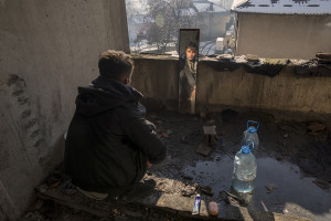 A migrant is portrayed through a mirror inside an abandoned building in Bihac, Bosnia and Herzegovina on January 27, 2021. Lots of migrants avoid staying inside the Bosnian official refugee camps because of the hard conditions in which they are forced to live and also because the people hosted in the official camps  cannot go out freely.