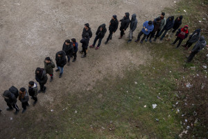 Migrants lined up during the food distribution outside an abandoned building in Bihac, Bosnia and Herzegovina on January 21, 2021. Lots of migrants avoid staying inside the Bosnian official refugee camps because of the hard conditions in which they are forced to live and also because the people hosted in the official camps  cannot go out freely.