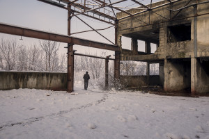 A migrant crosses the snow-covered fields near an abandoned factory in Bihac, Bosnia and Herzegovina on January 26, 2021. Lots of migrants avoid staying inside the Bosnian official refugee camps because of the hard conditions in which they are forced to live and also because the people hosted in the official camps  cannot go out freely.