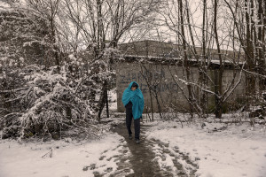 A migrant crosses the snow-covered fields near an abandoned factory in Bihac, Bosnia and Herzegovina on January 26, 2021. Lots of migrants avoid staying inside the Bosnian official refugee camps because of the hard conditions in which they are forced to live and also because the people hosted in the official camps  cannot go out freely.