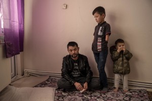 Abdul, 40 years old (left) from Takhar province, Afghanistan is seen with his children Fazel, 9 years old (center) and Mohammad, 2 years old (right) inside the house where they live in Van, Turkey on October 25, 2021. Abdul arrived in Turkey for about two months paying 7200 dollars for the entire family.