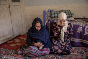 Tayiba, 17 years old (left) and her sister Wida, 22 years old from Afghanistan are seen inside the house where they have lived for three weeks in Van, Turkey on October 21, 2021. Tayba and Wida paid 250 dollars each to get from Afghanistan to Iran and 9300 Turkish lira to get to Turkey from Iran. When they arrived in Turkey they were forced to stay one day in a house before the smugglers received the money required for organizing their trip.