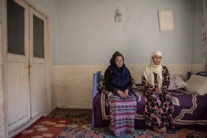 Tayiba, 17 years old (left) and her sister Wida, 22 years old from Afghanistan are seen inside the house where they have lived for three weeks in Van, Turkey on October 21, 2021. Tayba and Wida paid 250 dollars each to get from Afghanistan to Iran and 9300 Turkish lira to get to Turkey from Iran. When they arrived in Turkey they were forced to stay one day in a house before the smugglers received the money required for organizing their trip.