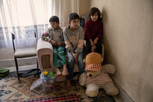 Rashad, 9 years old (left), Bahram, 10 years old (center) and Soraya, 7 years old (right) from Afghanistan are seen inside the house where they have lived with their mother for about three months in Van, Turkey on October 21, 2021.