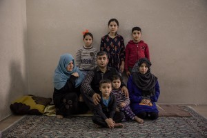 Mohammed, 38 years old (center) from Parwan province, Afghanistan is portrayed with his two wives and his five children inside the house where he lives in Van, Turkey on October 24, 2021. Mohammed arrived in Turkey for about a month and a half paying 7200 dollars for the entire family.