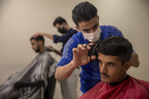 Refugees from Afghanistan have their hair cut at the Kurubas detention center in the border city of Van, Turkey on October 25, 2021. The center opened in April 2017 and hosts mostly Afghans arrested while trying to illegally enter Turkey via Iran. According to Cuma Omurca, director of the migration department in Van province, the goal is to stop irregular immigration and the activity of smugglers.