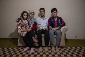 From left: Zahra, 4 years old, Maryam, 22 years old, Mujtaba, 19 years old and Sharif, 21 years old from Kabul, Afghanistan are portrayed inside the house where they live in Van, Turkey on October 21, 2021. When the Taliban took power in Afghanistan, they arrested their father but he managed to send them a message saying to flee the country. From that day on, the children have no longer been able to hear from their father. Their journey from Afghanistan to Turkey began about a month and a half ago. When they arrived in Turkey they were forced to stay fourteen day in a house before the smugglers received the money required for organizing their trip, that is 1100 dollars each.