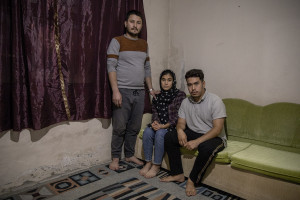 From left: Mohammed, 32 years old, Zahra, 20 years old and Murtaza, 19 years old from Afghanistan are portrayed inside the house where they live in Van, Turkey on October 21, 2021.
