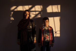 Uzra, 45 years old and her son Muhsen, 8 years old from Afghanistan are portrayed inside the house where they live in Van, Turkey on October 21, 2021.